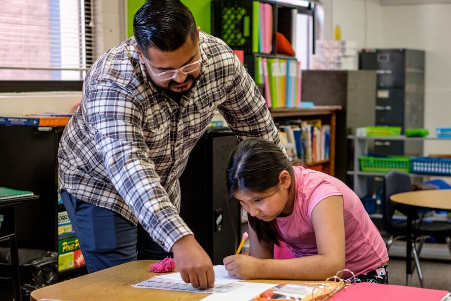 Brian Campos works with a student.